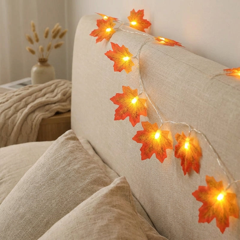 Decorative string lights with leaf design on a beige sofa.