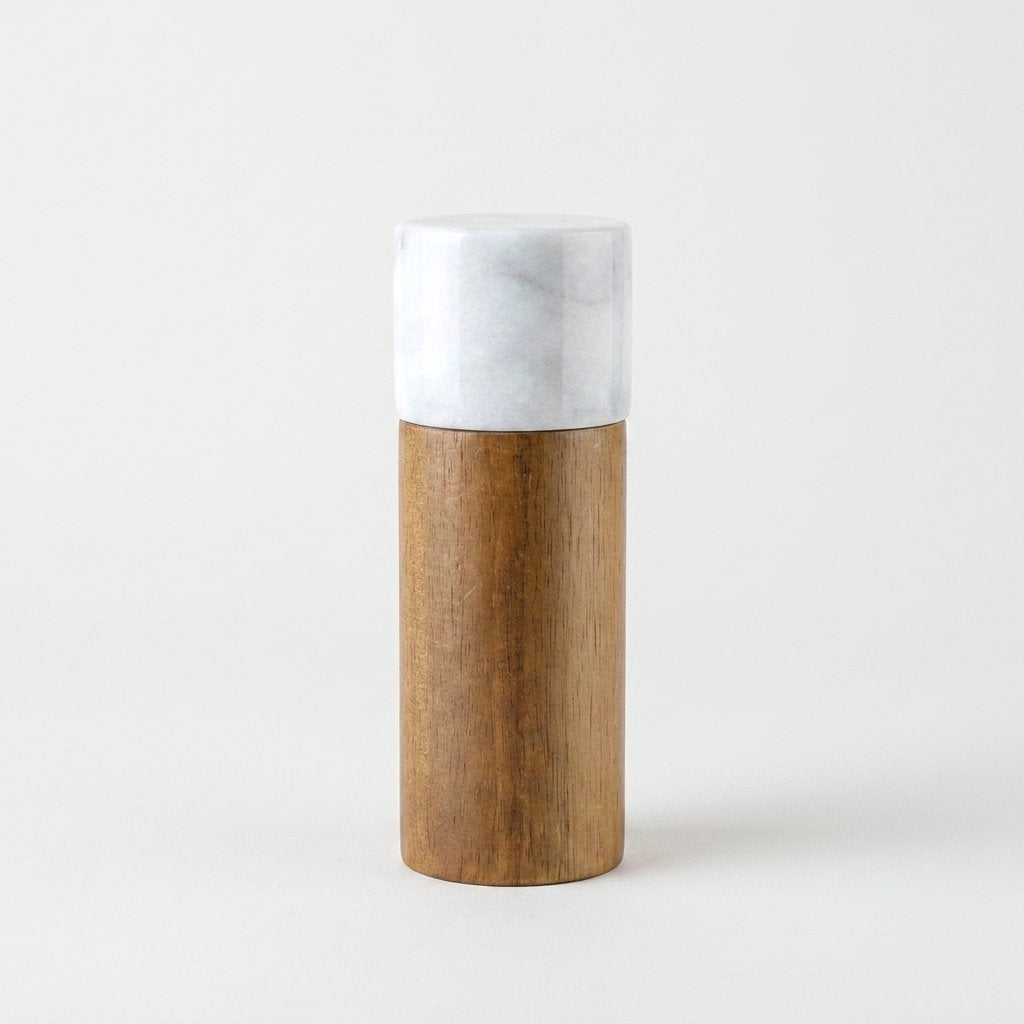 White marble-topped acacia wood hidden grinder mill on a light studio background