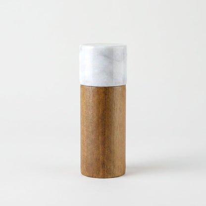 White marble-topped acacia wood hidden grinder mill on a light studio background