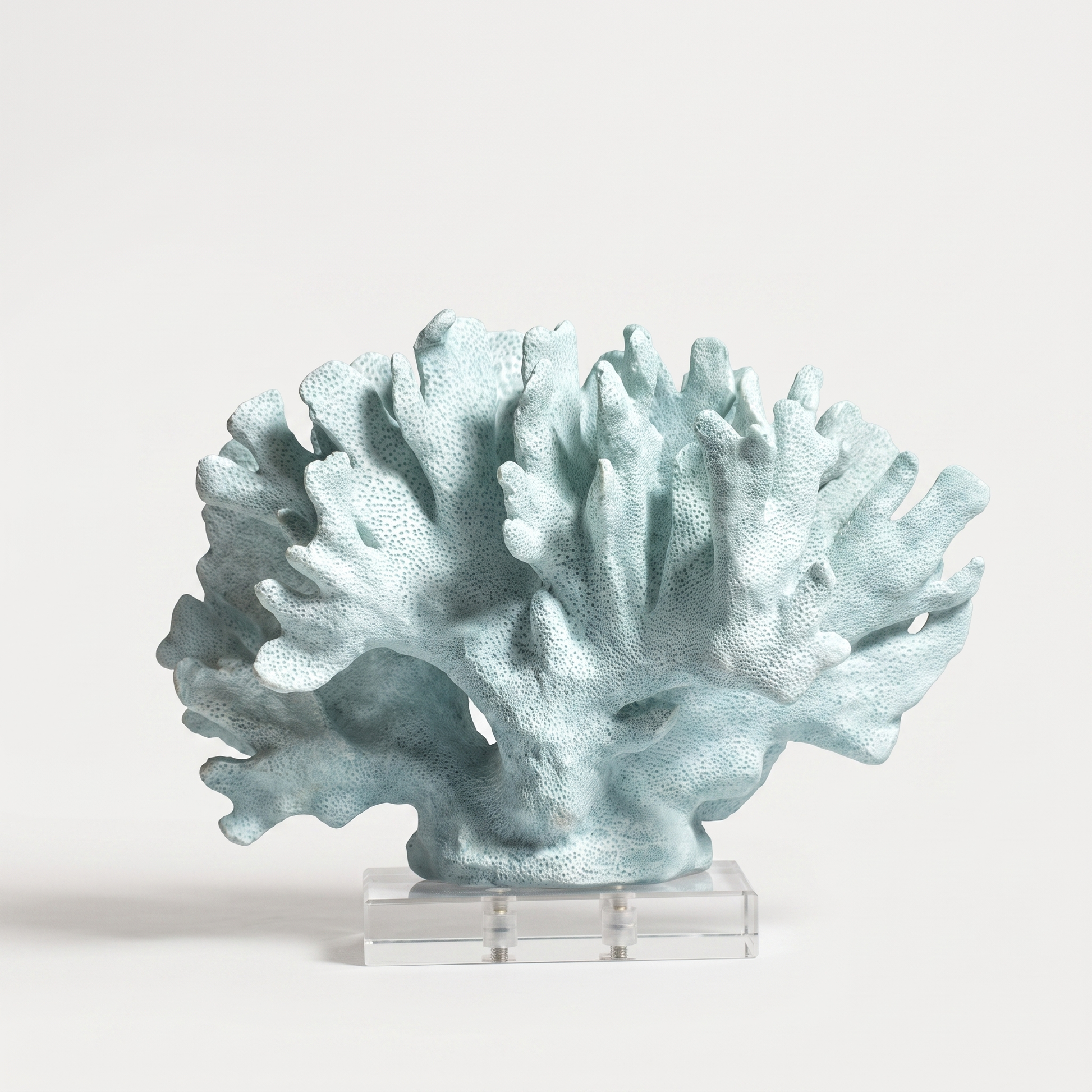 Blue marble coral sculpture on a marble base, off-white background