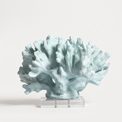 Blue marble coral sculpture on a marble base, off-white background