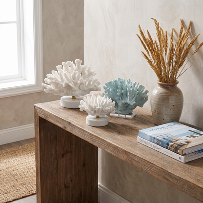 Group of marble coral sculptures displayed together on a console table