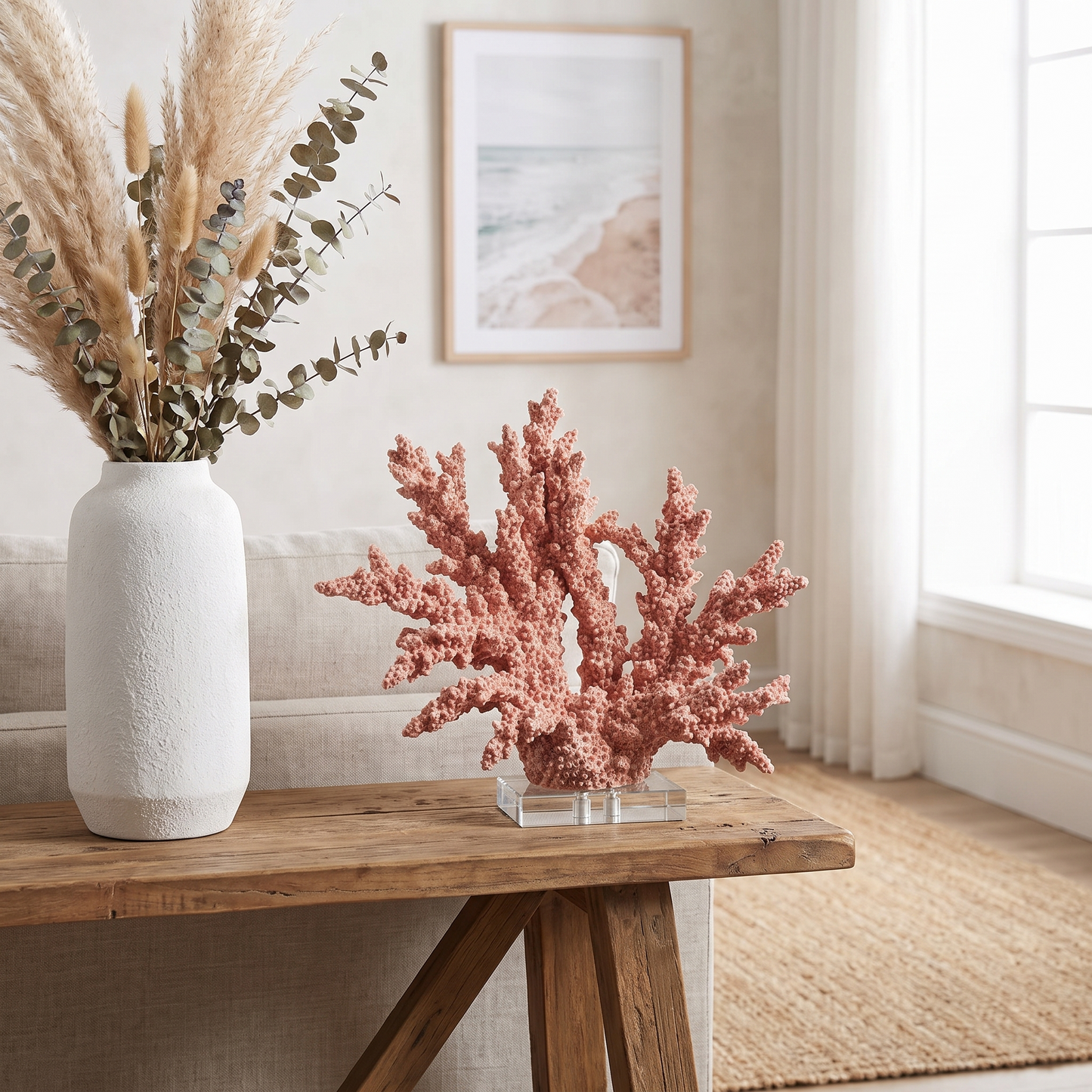 Pink marble coral sculpture styled on a shelf with greenery, coastal home decor