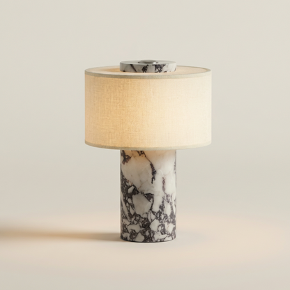 Table lamp with marble base and beige shade on a light background