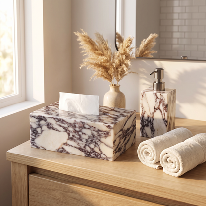 Calacatta marble tissue box cover on a bathroom vanity beside folded towels