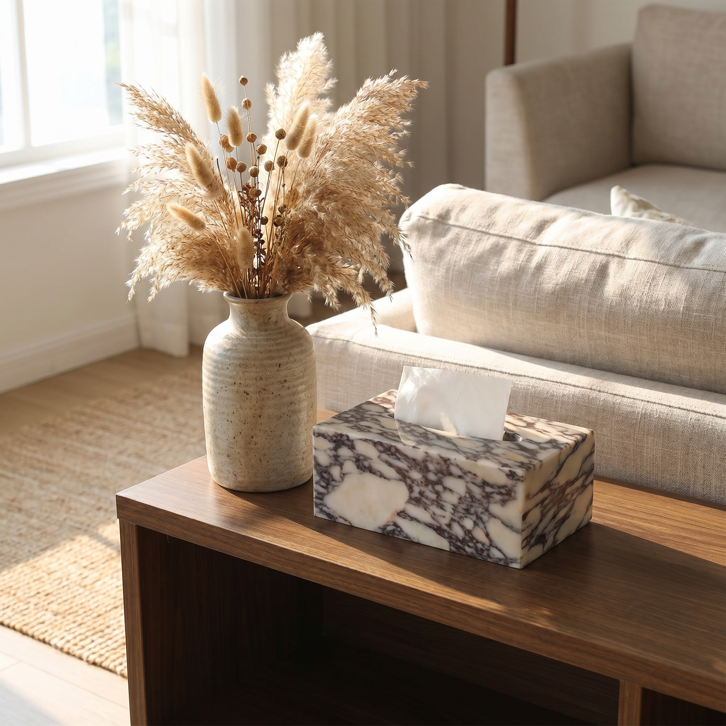 Calacatta marble tissue box cover on a living room console beside a vase