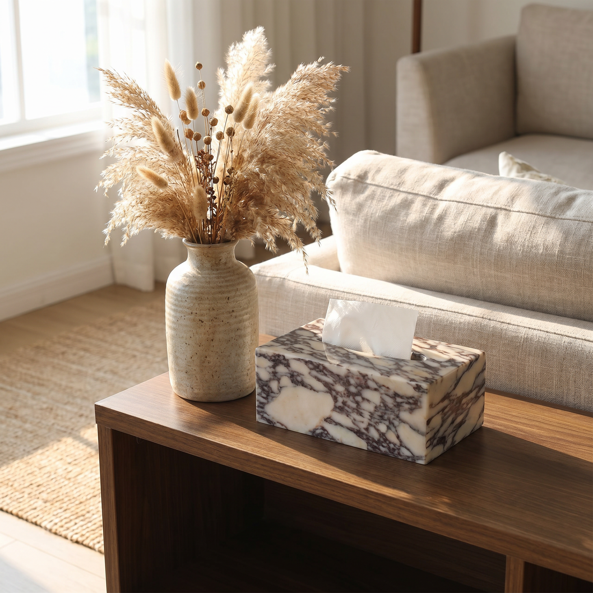 Calacatta marble tissue box cover on a living room console beside a vase
