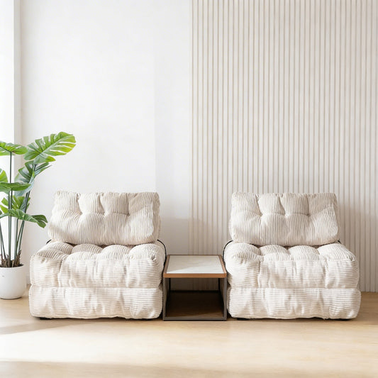 Two white cushioned chairs with a small table between them in a minimalistic room.