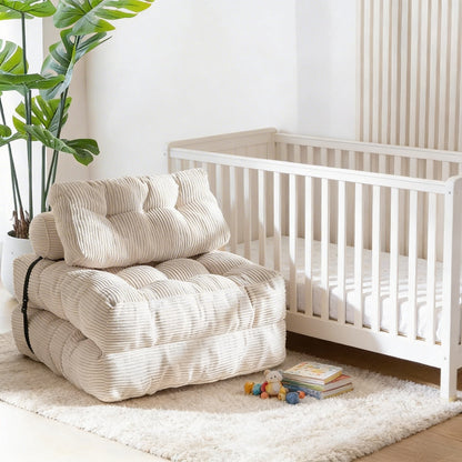 Foldable chair in a room with a crib and toys on a rug