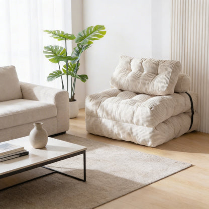 Modern living room with a beige armchair, coffee table, and plant.
