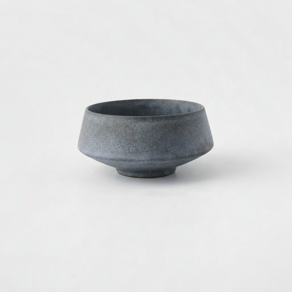 Medium matte speckled blue-gray stoneware bowl on a light grey background
