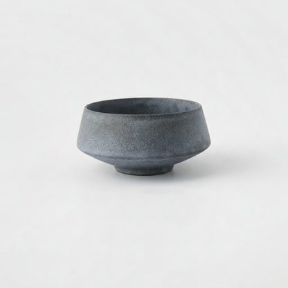 Medium matte speckled blue-gray stoneware bowl on a light grey background