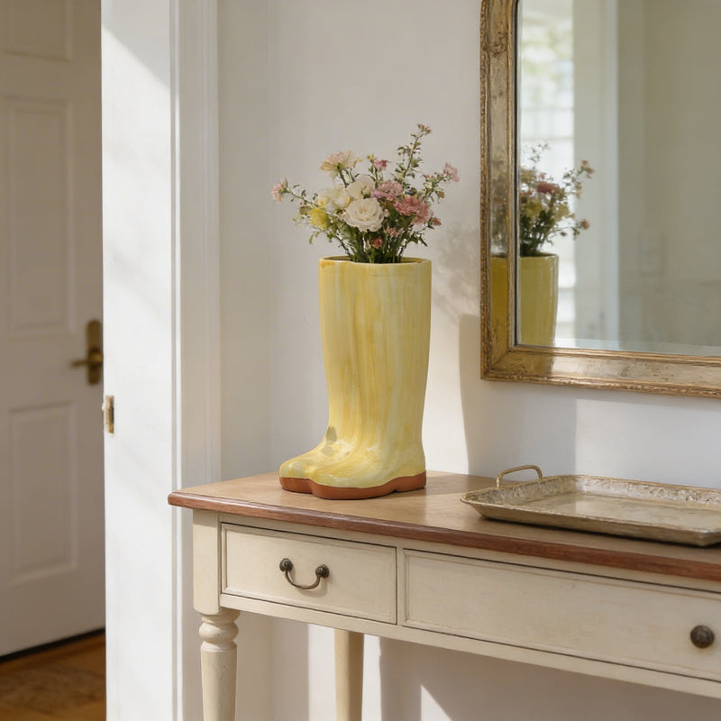 Gold Meadow boot vase on console table beside mirror