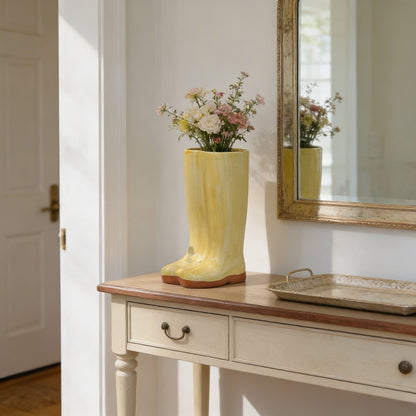 Gold Meadow boot vase on console table beside mirror