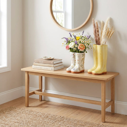 Meadow boot vase with flowers on entry bench in bright interior