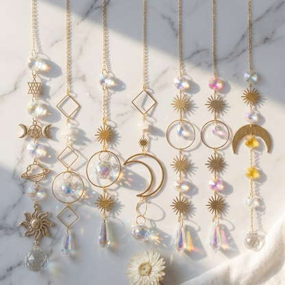 Meditation suncatchers set with moon, sun, and crystal designs hanging in window light
