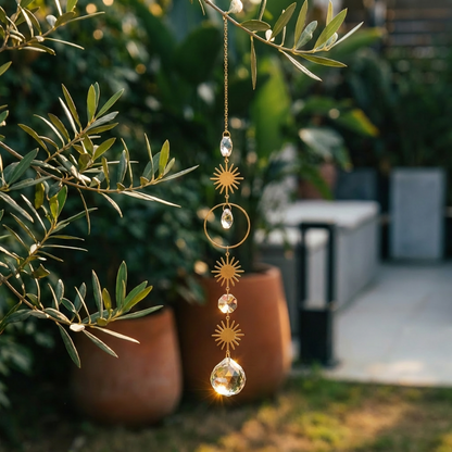 Meditation suncatcher hanging outdoors beside potted plants