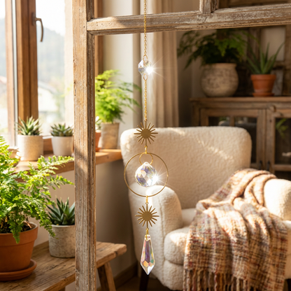 Decorative hanging crystal in a cozy living room with plants and a chair.