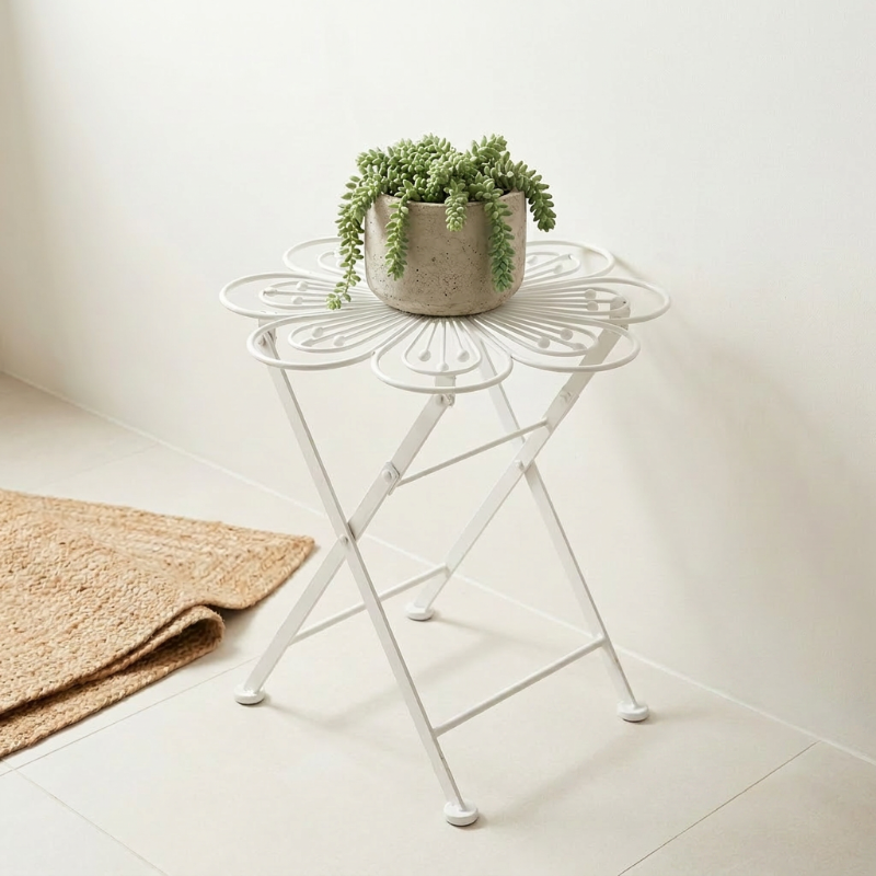 Metal flower bistro table beside chair on outdoor patio