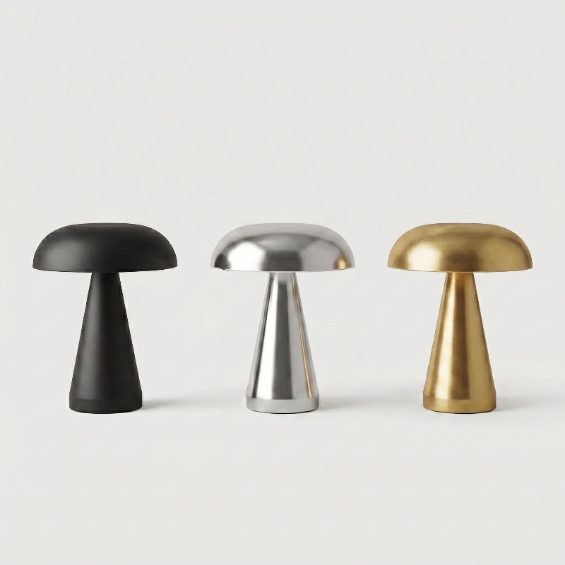 Metallic mushroom table lamps in black, silver, and gold on white background