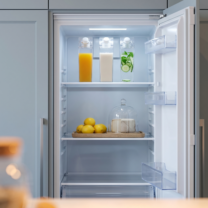 Milk carton style water bottles in refrigerator with drinks and fruit