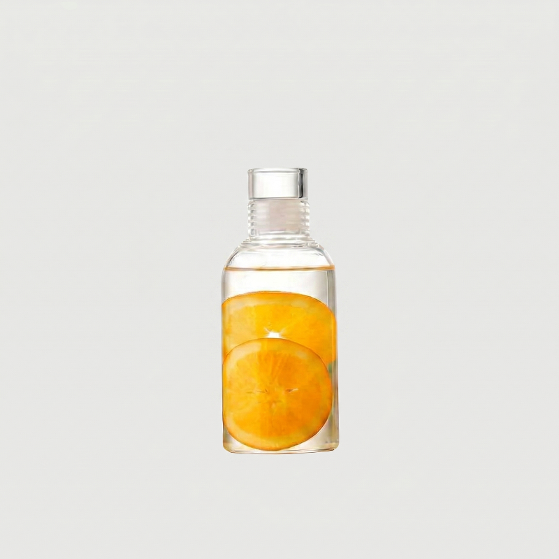 Clear bottle with sliced oranges inside on a light gray background