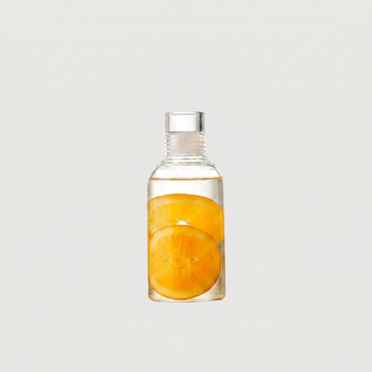 Clear bottle with sliced oranges inside on a light gray background