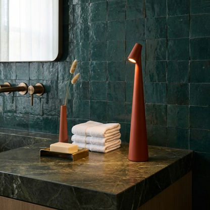 Minimalist rechargeable table lamp on a bathroom counter