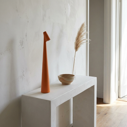 Minimalist rechargeable table lamp on a console table