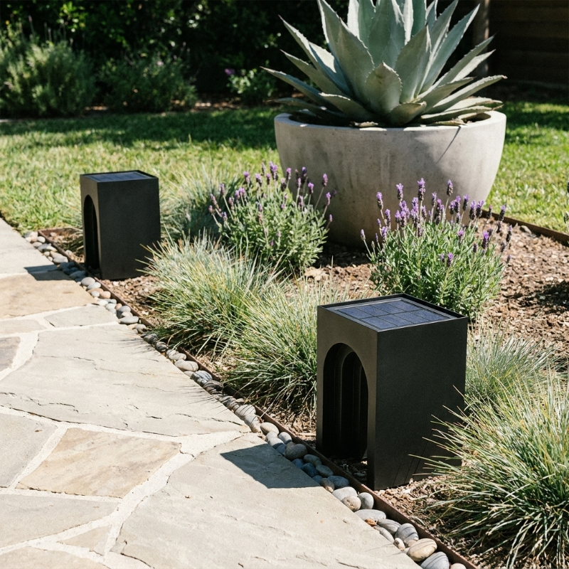 Modern arch solar lantern on stone patio beside succulent planter