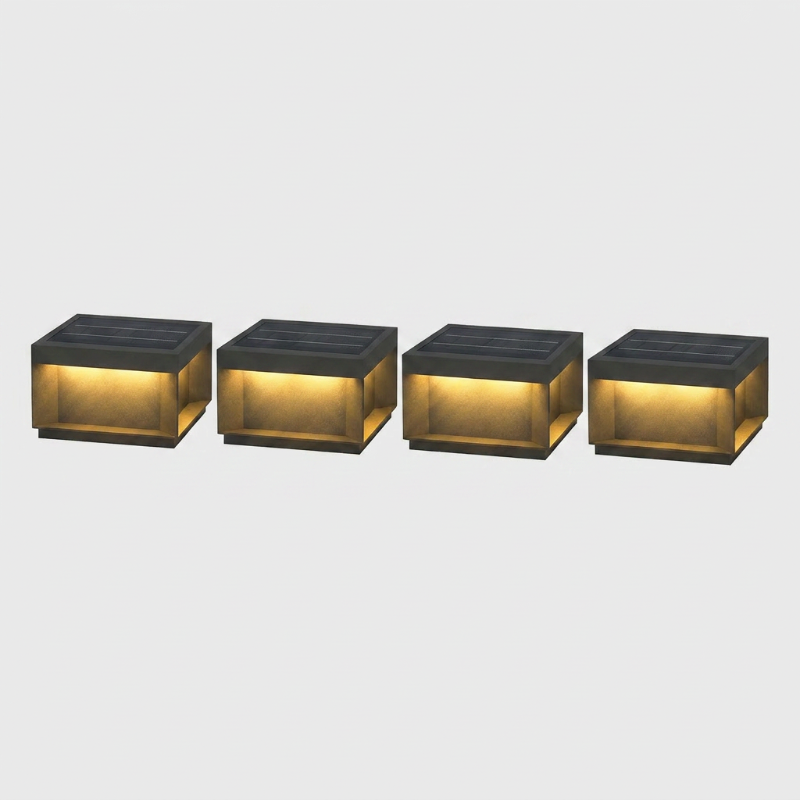 Set of four modern black LED solar outdoor deck lights on white background