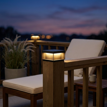 Modern black LED solar outdoor deck lights along a house walkway at twilight