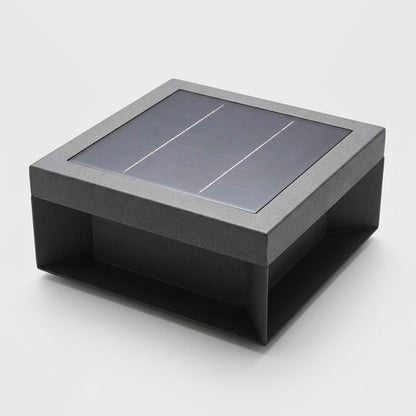 Single black solar deck light with a dark solar panel top on a light gray studio background