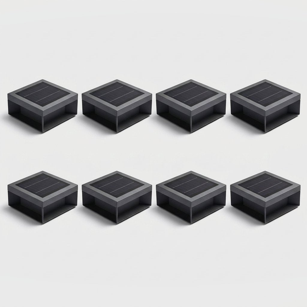 Set of eight black solar deck lights arranged in two rows of four on a light gray studio background