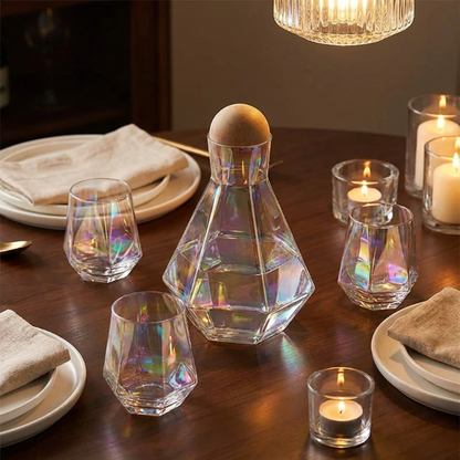 Iridescent glassware and candles on a dining table with a warm light fixture.