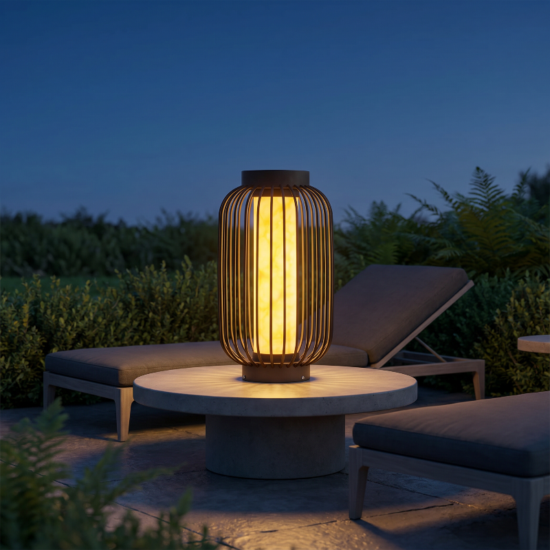 Modern outdoor solar lantern on round side table outdoors at sunset