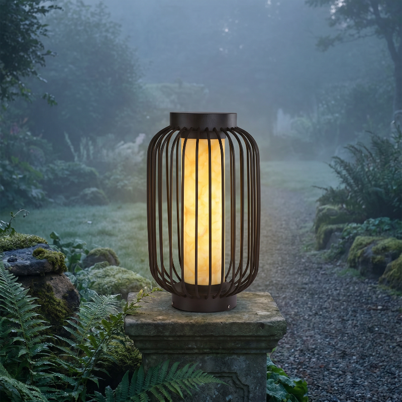 Modern outdoor solar lantern glowing on stone pedestal in misty garden