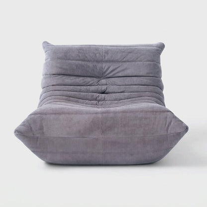 Light gray corduroy tufted lounge chair seen from the front on a light studio background