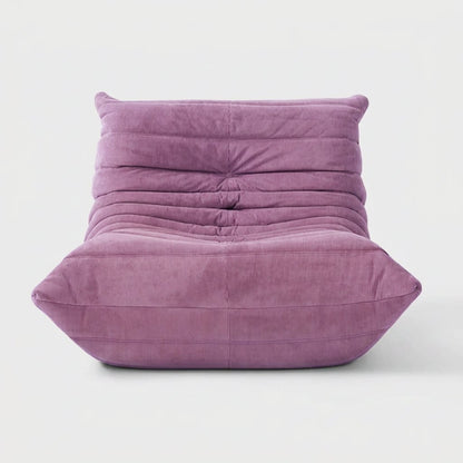 Lilac purple corduroy tufted lounge chair seen from the front on a light studio background