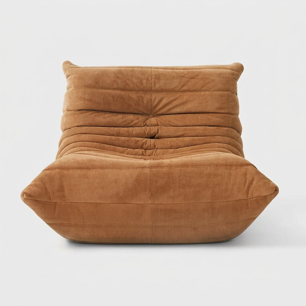 Tan corduroy tufted lounge chair seen from the front on a light studio background