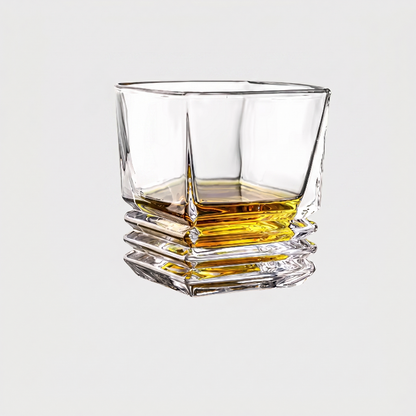 Clear glass with whiskey on a light gray background