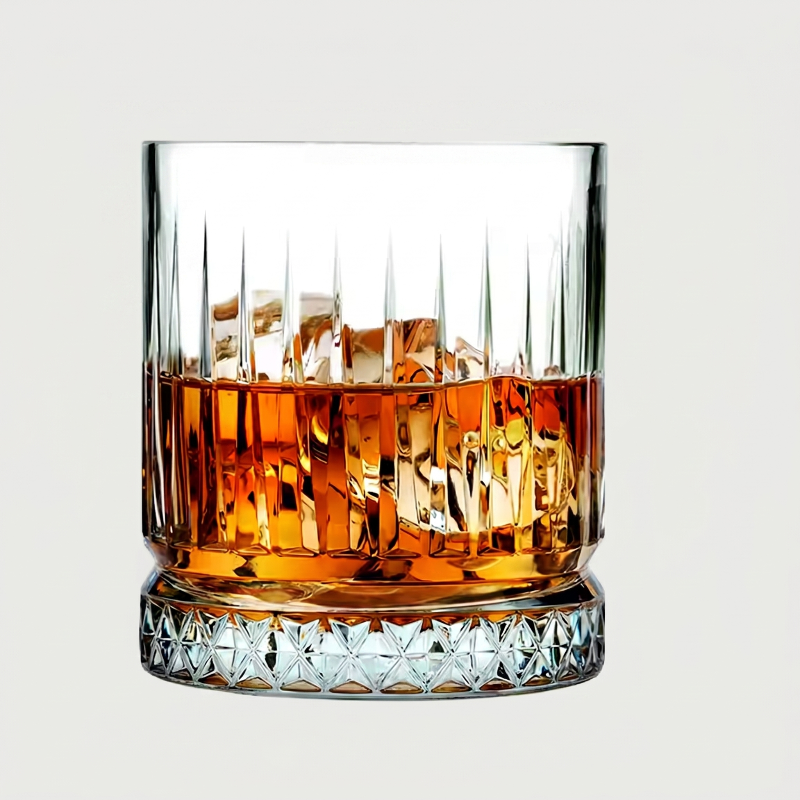 Crystal glass filled with whiskey on a light gray background