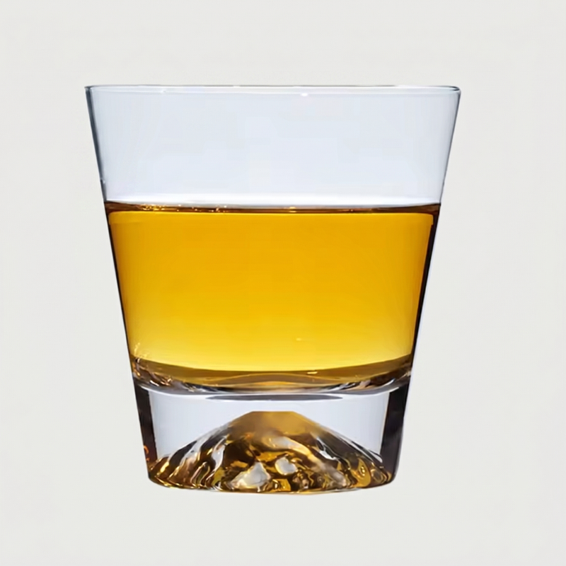 Glass of amber liquid on a light gray background