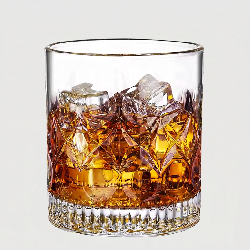 Glass of whiskey with ice cubes on a light gray background