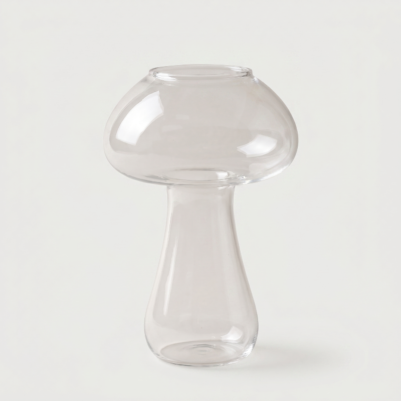 Clear mushroom cocktail glass on white background