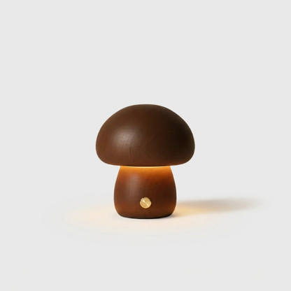 Dark wood mushroom table lamp with warm glow on white background