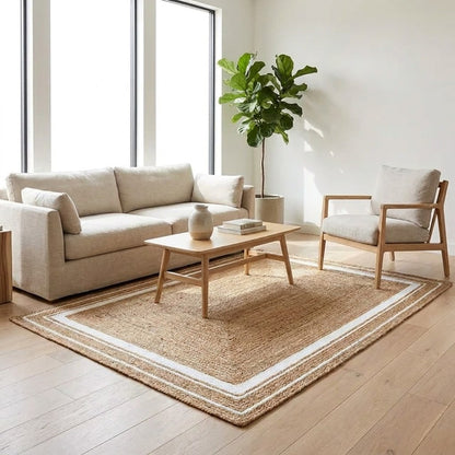 Natural jute hand-woven rug with ivory border styled in a living room, Kiyo Home