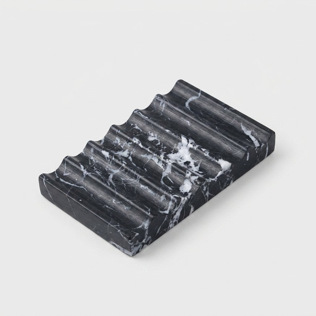 Black marble Natural Marble Soap Dish with white veining, ridged draining grooves, hero shot on a clean off-white background