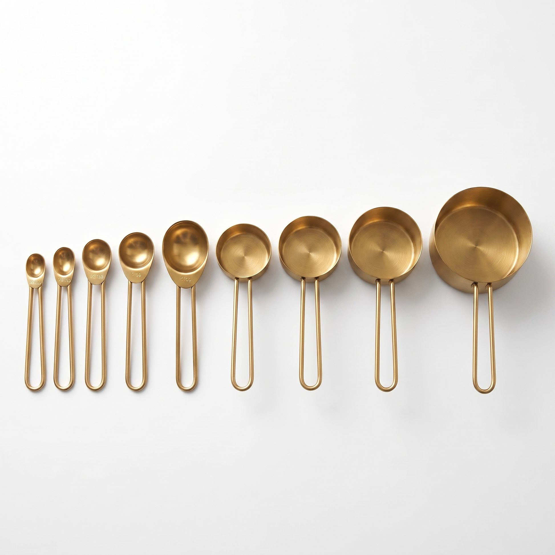 9-Piece Gold Stainless Steel Measuring Set with 5 spoons and 4 cups arranged on a clean off-white background