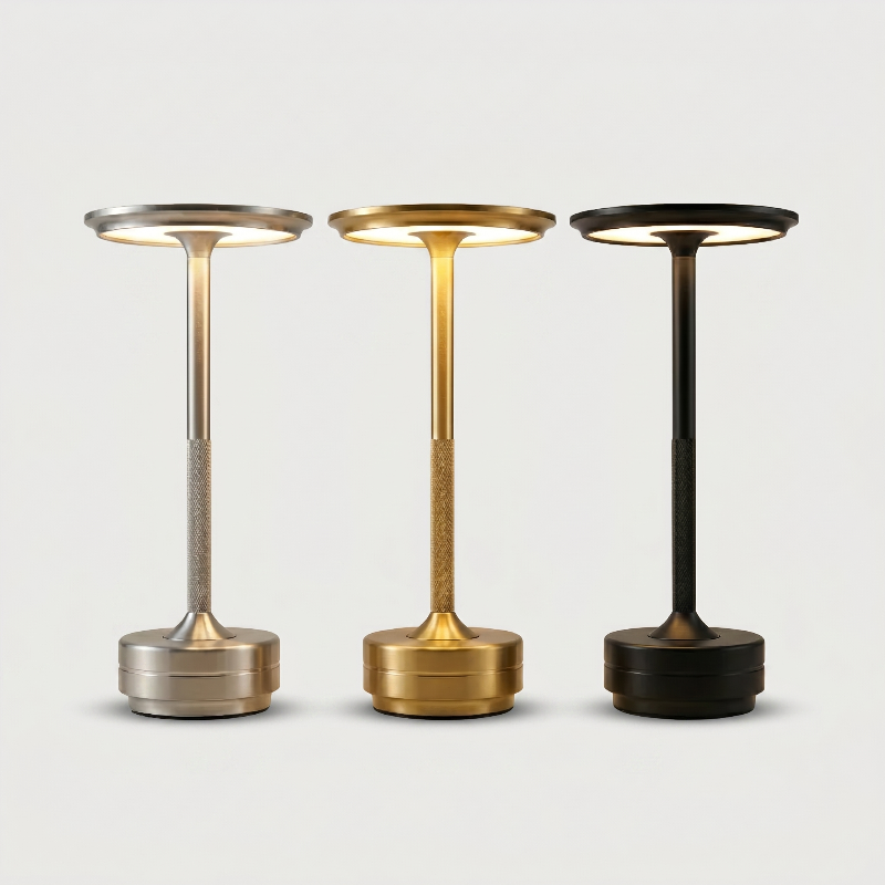 Three standing lamps in silver, gold, and black on a light gray background